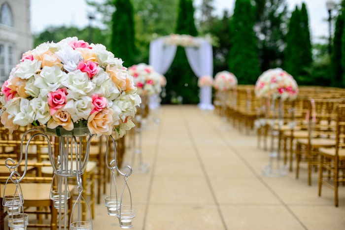 Outdoor evening reception with warm tent lighting and round tables