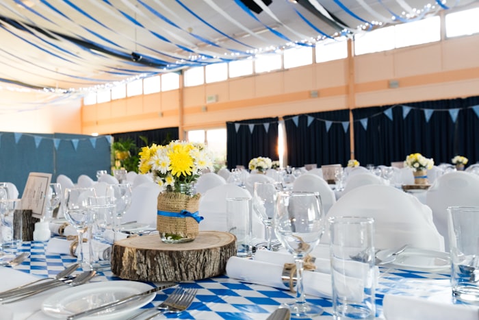 Elegant table setting with gold chargers at an outdoor reception